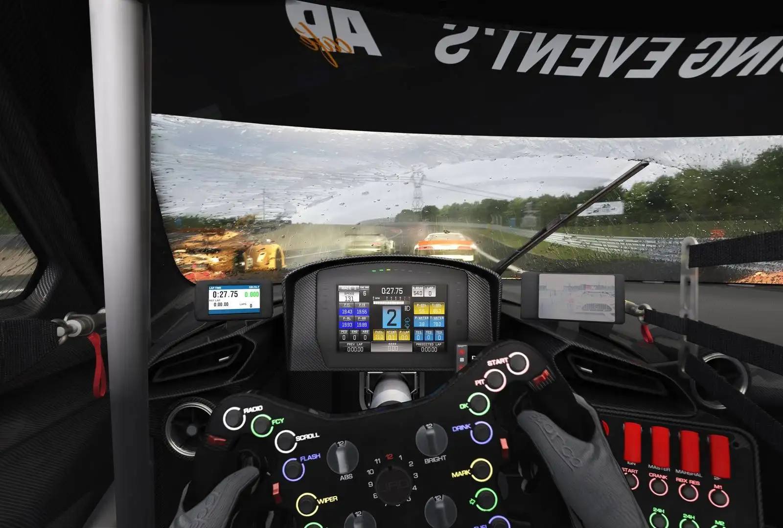 Blick aus dem Cockpit eines Rennwagens bei Regen: beleuchtetes Renn-Lenkrad, laufender Scheibenwischer, nasse Strecke mit Gischt der vorausfahrenden Fahrzeuge
